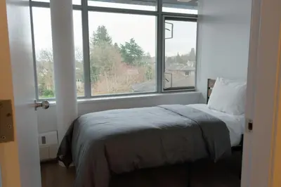 a bedroom with a bed in front of a window at Carey Centre on UBC campus in Vancouver
