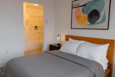 a bedroom with a bed and a picture on the wall at Carey Centre on UBC campus in Vancouver