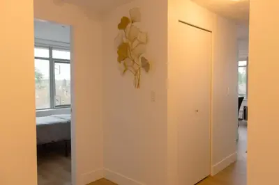 a hallway with a door leading to a bedroom at Carey Centre on UBC campus in Vancouver