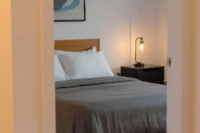 a bedroom with a bed and a lamp on a table at Carey Centre on UBC campus in Vancouver