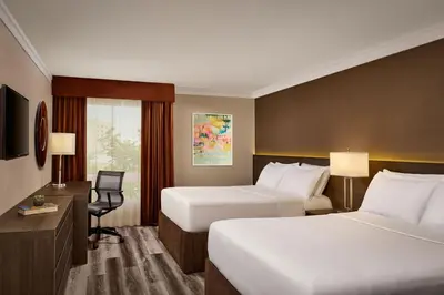 a hotel room with two beds and a desk at Varscona Hotel on Whyte in Edmonton