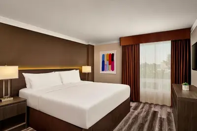 a bedroom with a large white bed and a window at Varscona Hotel on Whyte in Edmonton