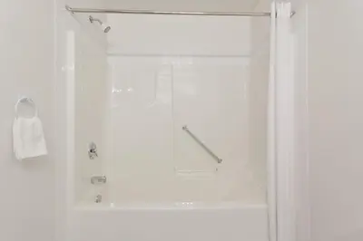 a bathroom with a shower with a glass door at Super 8 by Wyndham Valemount in Valemount