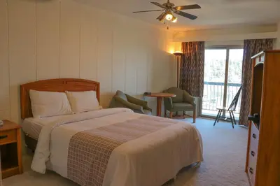 a hotel room with a bed and a balcony at The Waterfront Suites and Marina in Nanaimo