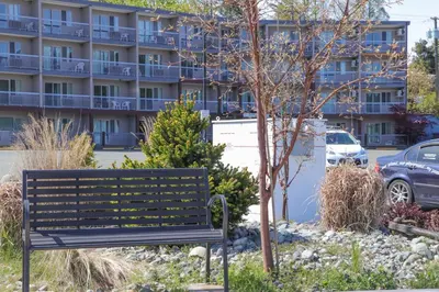 a park bench in front of a building at The Waterfront Suites and Marina in Nanaimo