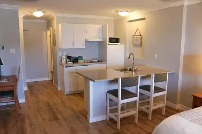a kitchen with a sink and a counter in a room at The Waterfront Suites and Marina in Nanaimo