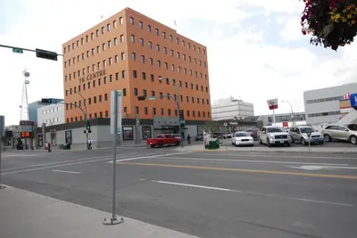 an empty city street with a large brick building at Discovery Inn in Yellowknife