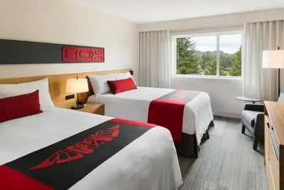 a hotel room with two beds and a window at Kwa'lilas Hotel in Port Hardy