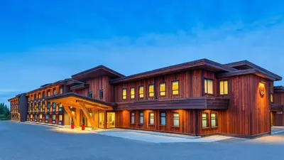 a large wooden building with a lot of windows at Kwa'lilas Hotel in Port Hardy