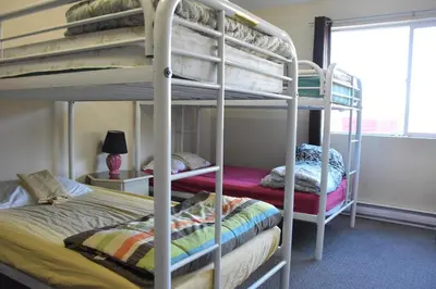 a bunk bed room with two bunk beds in it at North Coast Trail Backpackers Ltd in Port Hardy