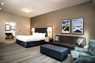 a hotel room with a bed and a couch at Mountaineer Lodge in Lake Louise