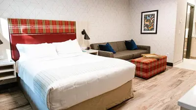 a hotel room with a bed and a couch at Mountaineer Lodge in Lake Louise