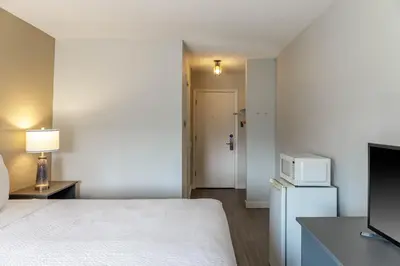 a hotel room with a bed and a microwave at Motel 6 Merritt, BC in Merritt