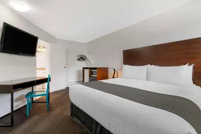 a hotel room with a large bed and a desk at Stoke Hotel SureStay Collection by Best Western in Revelstoke