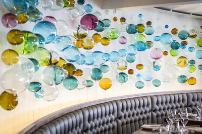 a bunch of glass bubbles hanging on a wall at Qualicum Beach Inn in Qualicum Beach