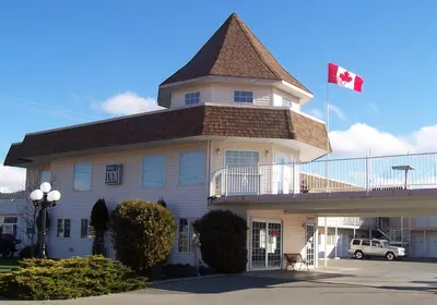 a building with a canadian flag on top of it at Model A Inn in Cranbrook