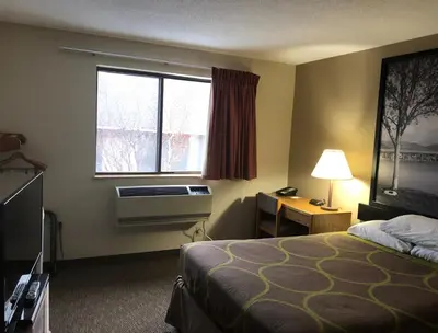 a hotel room with a bed and a window at Super 8 by Wyndham Salmon Arm in Salmon Arm
