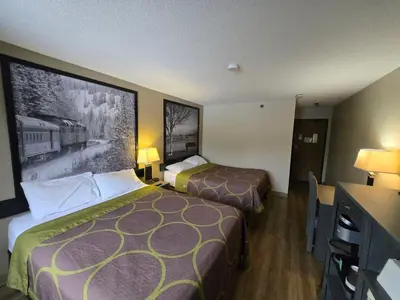 a hotel room with two beds and a picture on the wall at Super 8 by Wyndham Salmon Arm in Salmon Arm