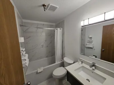 a bathroom with a toilet and a sink and a shower at Super 8 by Wyndham Salmon Arm in Salmon Arm