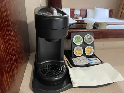 a black coffee maker next to a hotel room at Monashee Lodge in Revelstoke