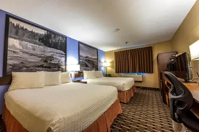 a hotel room with two beds and a tv at Super 8 by Wyndham Kamloops On The Hill in Kamloops