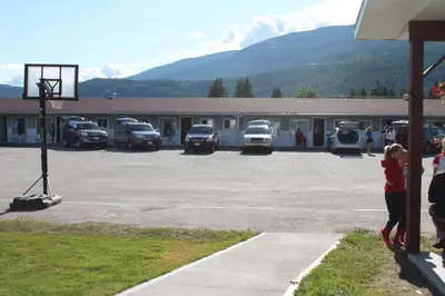a group of cars parked in a parking lot at Paradise Motel in Sicamous