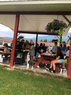 a group of people sitting at a picnic table at Paradise Motel in Sicamous