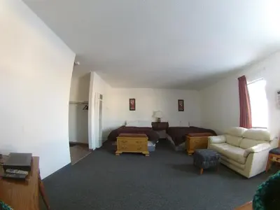 a living room with a bed and a couch at Rycroft Hotel in Rycroft