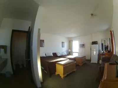 a bedroom with a bed and a couch in it at Rycroft Hotel in Rycroft