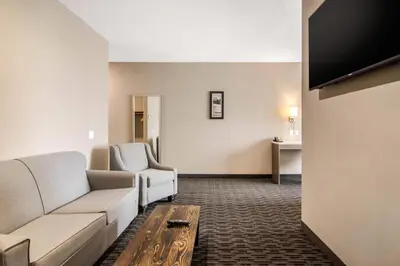 a living room with a couch and a table at Comfort Inn & Suites in North Battleford