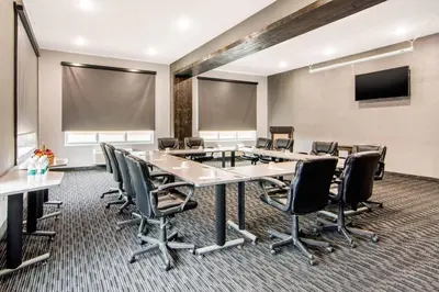 a conference room with a large table and chairs at Comfort Inn & Suites in North Battleford