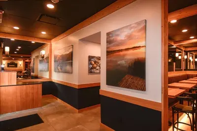 a restaurant with a large painting on the wall at Harbour House Hotel in Ganges