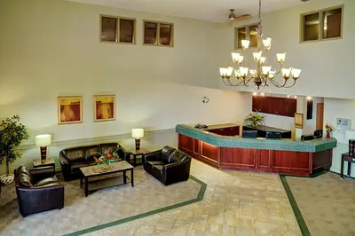 a lobby with couches and a bar in a building at Nova Inn Acheson in Spruce Grove
