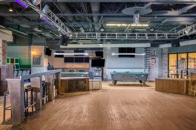 a large room with a pool table and a bar at Days Inn & Conference Centre by Wyndham Camrose Norsemen in Camrose