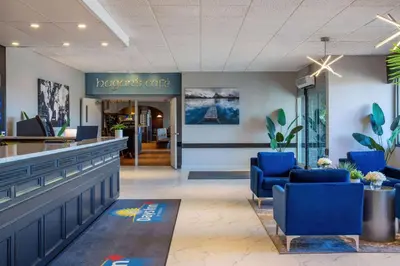 a lobby of a dermatologists office with blue chairs at Days Inn & Conference Centre by Wyndham Camrose Norsemen in Camrose