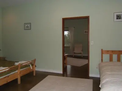 a bedroom with two beds and a door to a room at Baergnaescht B&B in Osoyoos