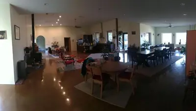a living room with tables and chairs and a dining room at Baergnaescht B&B in Osoyoos