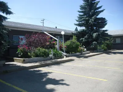 a parking lot in front of a building at Stardust Motel in Camrose