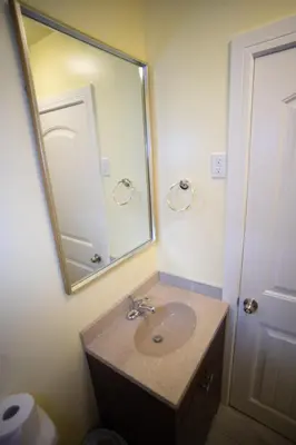 a bathroom with a sink and a mirror at Stardust Motel in Camrose