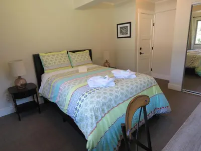 a bedroom with a bed with two towels on it at Bear Valley Guesthouse in Stewart