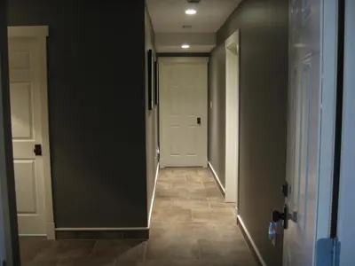 a hallway with a white door and a tile floor at Fitzhugh House Guest Accomodation in Jasper
