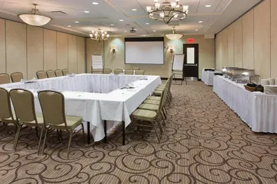 a conference room with a long table and chairs at Holiday Inn Hotel & Suites Red Deer by IHG in Red Deer