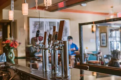 a bar with a row of wine glasses on a counter at Salt Spring Inn in Ganges
