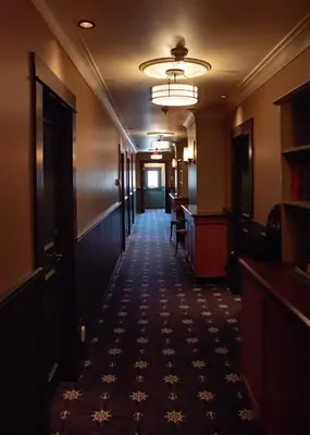 an empty hallway of a hotel with a long corridor at Salt Spring Inn in Ganges