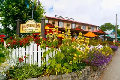 a garden of flowers in front of a building at Salt Spring Inn in Ganges