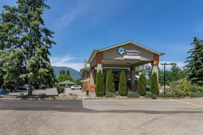 a hotel with a sign on the front of a building at SureStay Plus Hotel by Best Western Salmon Arm in Salmon Arm