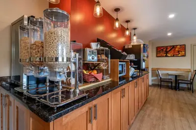a kitchen with a counter with some food at SureStay Plus Hotel by Best Western Salmon Arm in Salmon Arm