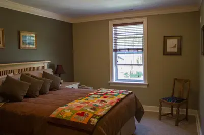 a bedroom with a bed and a window at Genelle House B&B Guest House in Genelle