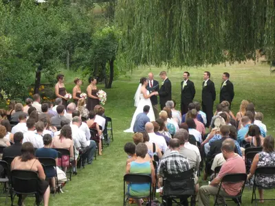a bride and groom are standing in front of a crowd at Genelle House B&B Guest House in Genelle