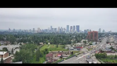 a cityscape of a city with a highway and buildings at Canadas Best Value Inn Chinook Station in Calgary